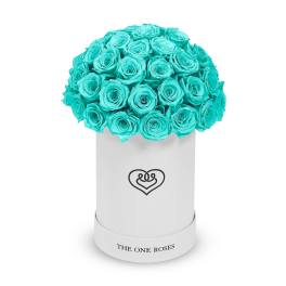 Turquoise roses arranged in a white hat box