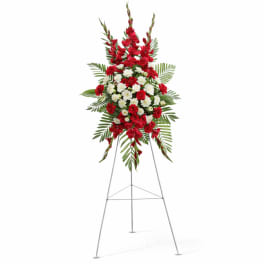 Standing floral spray of red and white flowers on an easel