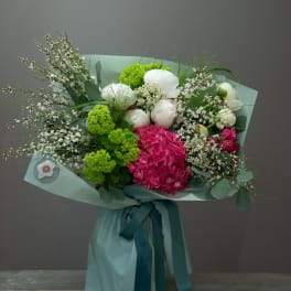 Bouquet of pink and white flowers wrapped in pale blue paper