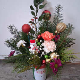 Holiday arrangement with carnations, ornaments, and a snowman in a Santa hat
