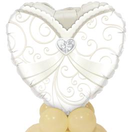 White heart-shaped balloon with gold swirls on a cluster of pale yellow balloons