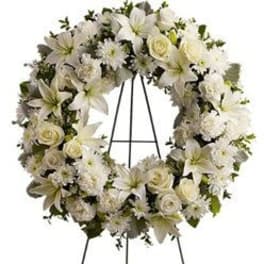 White floral wreath on a black easel