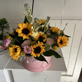 Pink box of sunflowers and small pink flowers