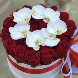 Red roses with white orchids in a round white box