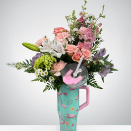 Pink and white mixed flower arrangement in a flamingo tumbler with lid and straw