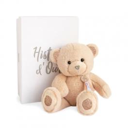 Plush teddy bear in front of a white book-shaped box