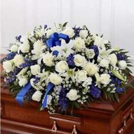 White and blue funeral spray on a casket