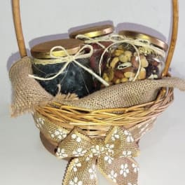 Basket of three lidded jars tied with ribbon
