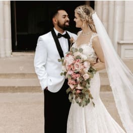 Bride and groom with a cascading pink bouquet