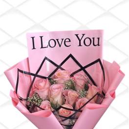 Pink rose bouquet wrapped with a "I Love You" card and black ribbon