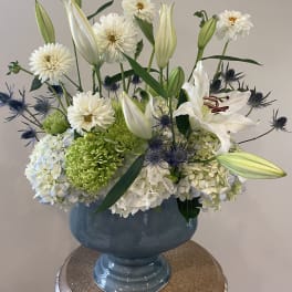 White lilies and mixed blooms in a blue vase