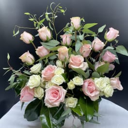 Bouquet of pink and white roses with greenery