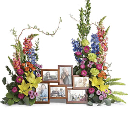 Floral photo frame display with colorful flowers and multiple picture frames