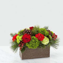 Red roses and carnations in a rectangular box with pine and berries