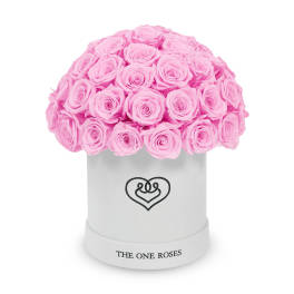 Pink roses arranged in a white round box