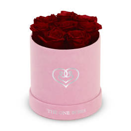 Red roses in a pink round box