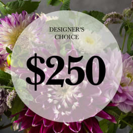 Designer’s choice floral arrangement with purple and white blooms