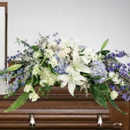 White and lavender floral casket spray with lilies and hydrangeas