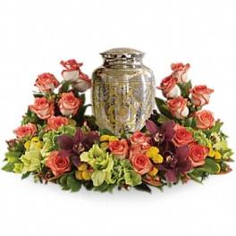 Floral arrangement with pink roses around a silver urn