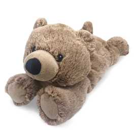Plush teddy bear lying on a white background
