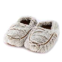 Pair of fuzzy beige slippers on a white background