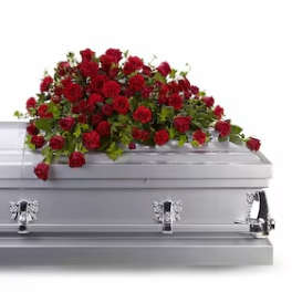 Red rose casket spray on a silver casket