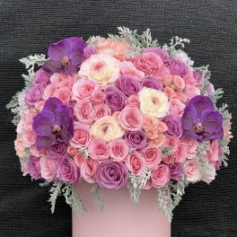 Pink and purple rose bouquet with orchids in a pink box