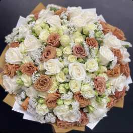 Bouquet of white and peach roses with small white filler flowers