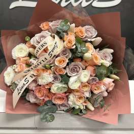 Bouquet of peach, blush, and white roses with eucalyptus