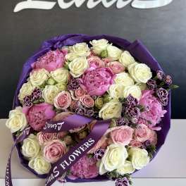 Round bouquet of pink and white roses with purple wrapping
