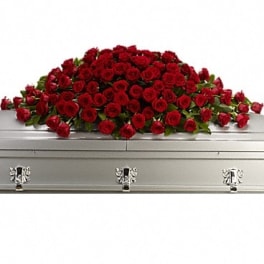 Red rose casket spray on a silver casket