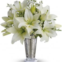 White lilies arranged in a silver vase