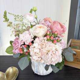 Pink and white floral arrangement in a white vase