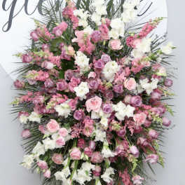 Large pink and white floral standing spray on an easel