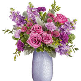 Pink and purple flower arrangement in a lavender vase