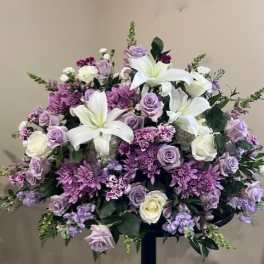 Large lavender and white floral spray with lilies and roses