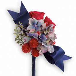 Bouquet of red roses and blue-purple flowers with a navy ribbon