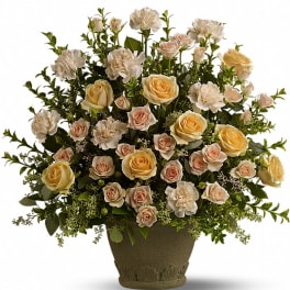 Cream and blush roses with white carnations in a decorative vase