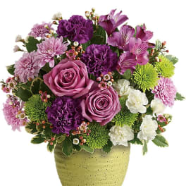 Purple and pink mixed bouquet in a speckled green vase