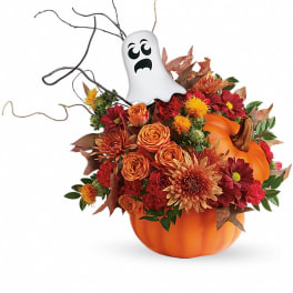 Halloween bouquet in a pumpkin container with a ghost pick