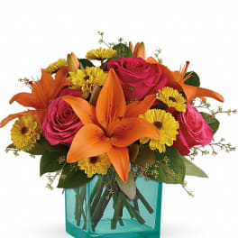 Orange lilies and pink roses in a turquoise vase