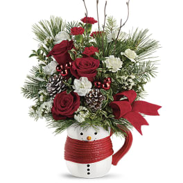 Christmas bouquet in a snowman mug with red roses and carnations
