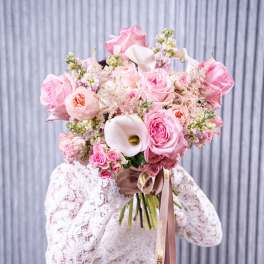 Pink rose and calla lily bouquet with ribbon accents