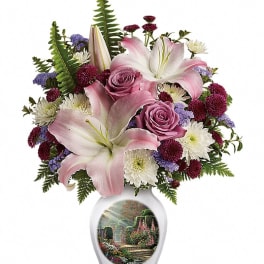 Pink lilies and roses in a white vase with a garden scene