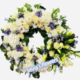 Circular floral wreath with white and pale yellow flowers and purple accents
