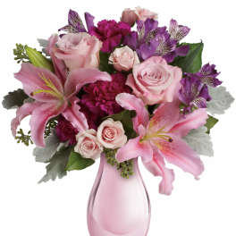 Pink and purple bouquet in a pink glass vase
