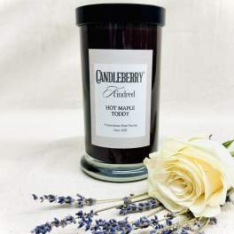 Black candle jar with a cream rose and lavender sprigs