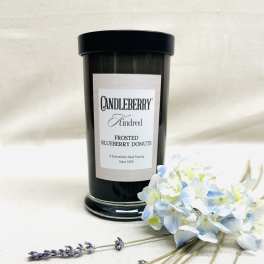 Black candle jar with a bouquet of pale blue and white flowers