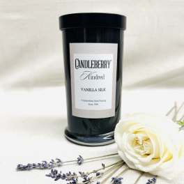 Black candle jar with a white rose and lavender sprigs