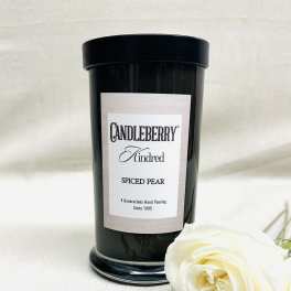 Black candle jar with a white rose and lavender sprigs
